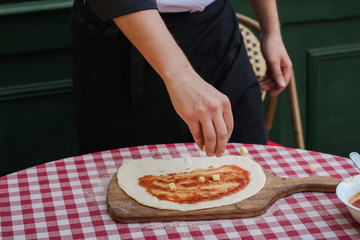 Chief making closed calzone pizza