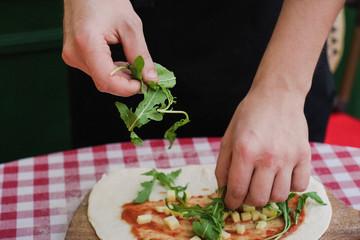 Chief making closed calzone pizza