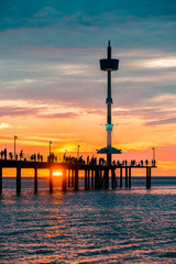 Brighton jetty with people silhouettes at sunset, South Australia 