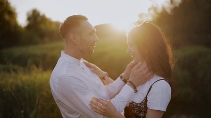 Passionate kiss couple in love at sunset with backlight.