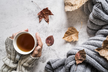 Crop woman with cup of hot tea