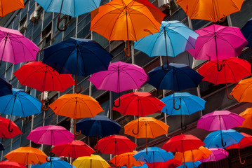 Fototapeta na wymiar Colorful umbrellas hanging next to each
