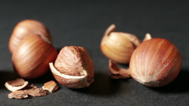 Tracking of some shelled hazelnuts with shell fragments around them, isolated on a black background