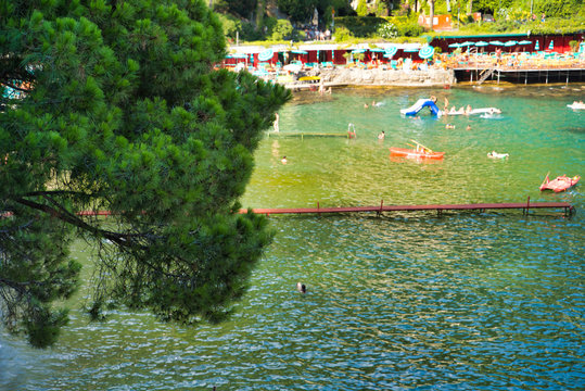 PARAGGI, LIGURIA, ITALY - AUGUST 15, 2019: Sandy Paraggi beach between the cities of Rapallo and Portofino. Vacation at a resort in Europe. Village in Tigullio Bay. Popular tourist destination