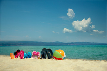 Fototapeta na wymiar Family slippers on the sand on the beach