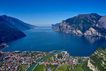 Panorama of Lake Garda surrounded by mountains in Riva del Garda, Italy. Lake Garda Italy. Aerial view - obrazy, fototapety, plakaty
