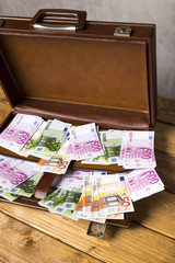 Close-up opened suitcase with euro banknotes