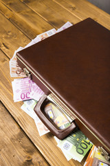 Close-up wooden suitcase with money inside