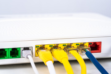 Close up of the back of a home router with colourful network cables