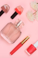 Obraz na płótnie Canvas Women cosmetics and flowers on a pink background.