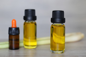 Peppermint essential oil in glass bottles on wooder background