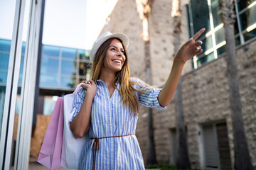 Beautiful woman with shopping bag. Sale, shopping, tourism and happy people concept