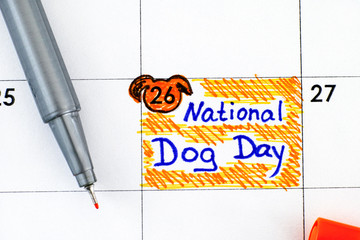 Reminder National Dog Day in calendar with pen.