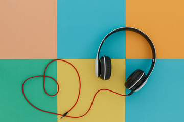 White music headphones  on a bright color tone  background,concept love  . Top view