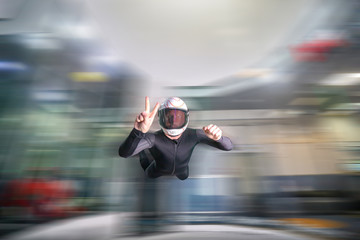 Image. Picture of a flying man. Skydiver hovers in the wind tunnel. Extreme hobby without age restrictions.