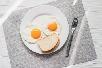 Healthy breakfast with fried eggs on wooden table