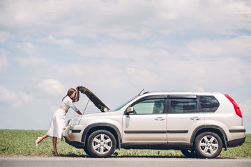 In a young beautiful woman's car was broken during the trip, she tries to call the tow truck