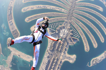 Dubai.People lies on Dubai Palm in free fall. Outdoor skydiving. Free fall on speed 200km/h. Summer...