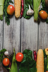 Healthy food clean eating selection. Corn, tomatoes, zucchini, carrot, beetroot, garlic, bean on wooden background. Food concept. Flat lay, top view. Free space for your text.