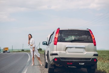 In a young beautiful woman's car was broken during the trip, she tries to call the tow truck