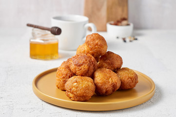 Cottage cheese balls doughnuts is jam-packed with jelly filling, cup of tea and honey