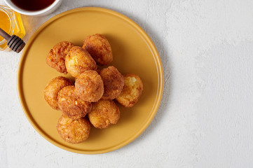 Cottage cheese balls doughnuts is jam-packed with jelly filling, cup of tea and honey