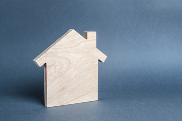 Obraz na płótnie Canvas Wooden figure of a house. concept of buying and selling real estate, rent, investment. Home, Affordable housing, residential building. Construction buildings. Minimalism and copyspace