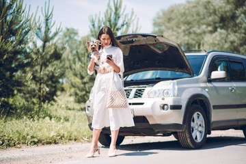 In a young beautiful woman's car was broken during the trip, she tries to call the tow truck