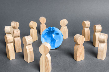 People surrounded a Globe world planet earth. Cooperation and collaboration of people around the...