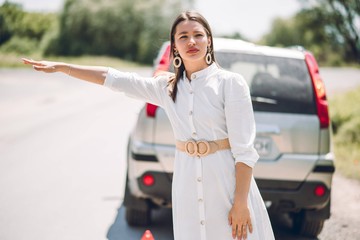 In a young beautiful woman's car was broken during the trip, she tries to call the tow truck
