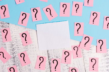 Scribbled and crumbling papers with thick cardboard above wooden table.