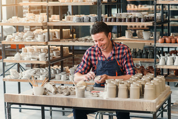 Talanted caucasian man making decoration for cup.