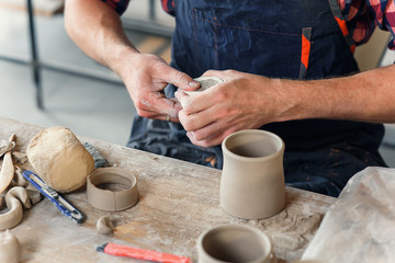 Talanted caucasian man making decoration for cup.