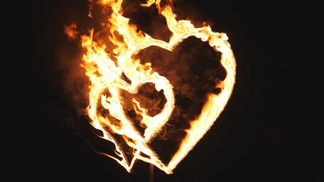 Burning hearts on the feast day of St. Valentine. A symbol of love. Slow motion.