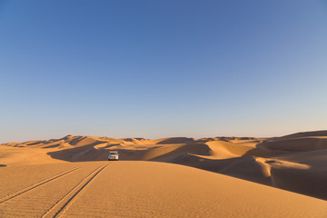 Fototapeta na wymiar Driving over sand dunes in the desert