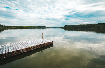 Wooden pier at the coast on the lake.