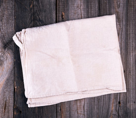folded gray linen towel on wooden background