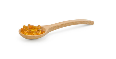 Vitamin pills and oil filled capsules (soft gel) in wooden spoon isolated on white background, Dietary supplement healthcare product Clipping part.