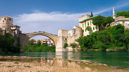 Stari Most bridge and its reflection in river Neretva - Old town of Mostar, Bosnia and Herzegovina, April 2019