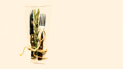 Simple laconic design cutlery on linen napkin on white table. Concept of natural organic eating. Copy space.