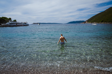 man leaving to swim in the sea