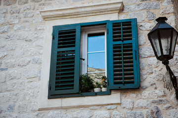 Fototapeta premium open window in an old stone house