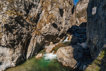 View of a famous Dovzan Gorge near Trzic, Slovenia. Big rock walls, cascade and a stream in Dovžan gorge, Tržič, Slovenia. Summer day in a turist destination Dovzan Gorge.