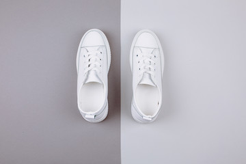 White sneakers on a gray background.
