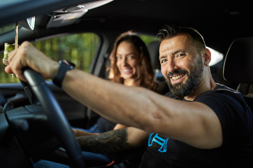 Happy couple with their new modern car