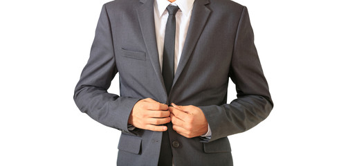 Young businessman in gray suit isolated against white background.