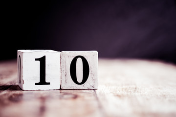 Number 10 isolated on dark background- 3D number ten isolated on vintage wooden table