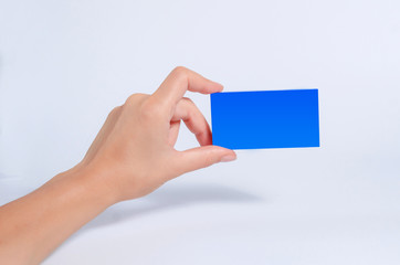 Obraz premium Female hand hold a blue tablet, business card, box on a white background.