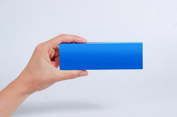 Female hand hold a blue tablet, business card, box on a white background.