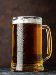 Close-up of a cold beer mug on a dark background